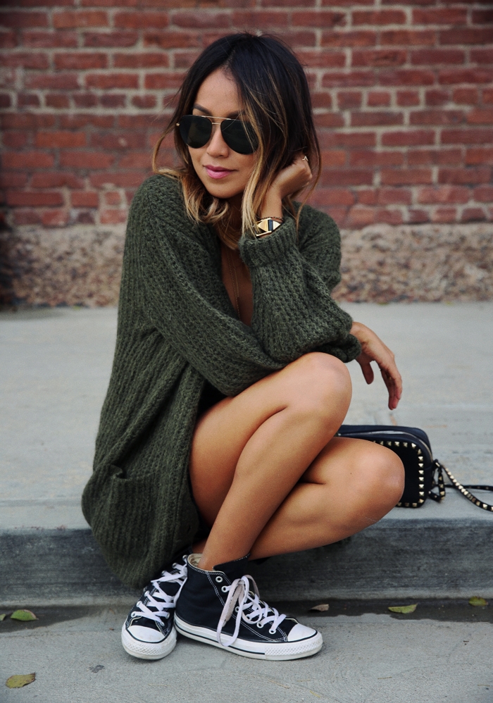 Julie Sarinana wears a cute green knit cardigan with her ankle high chuck taylors. Classic black converse really do go with anything! Cardigan: Anine Bing, Converse. 