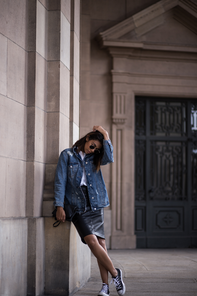 Converse are the perfect choice for almost any street style look. This urban style, consisting of an oversized denim jacket and a leather midi skirt, goes excellently with a pair of classic black converse. Via Storm and Andrea. Jacket: Stradivarius, Tee: ThirdForm, Skirt: Zara, Bag: Celine, Shoes: Converse