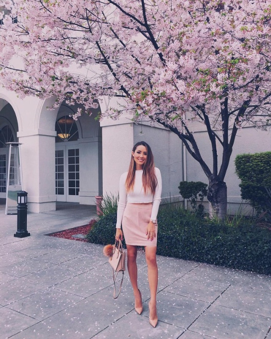 Jessica Ricks wears a gorgeous pink suede pencil skirt with a cropped white tee and nude heels to create this spring-ready style. Brands not specified.