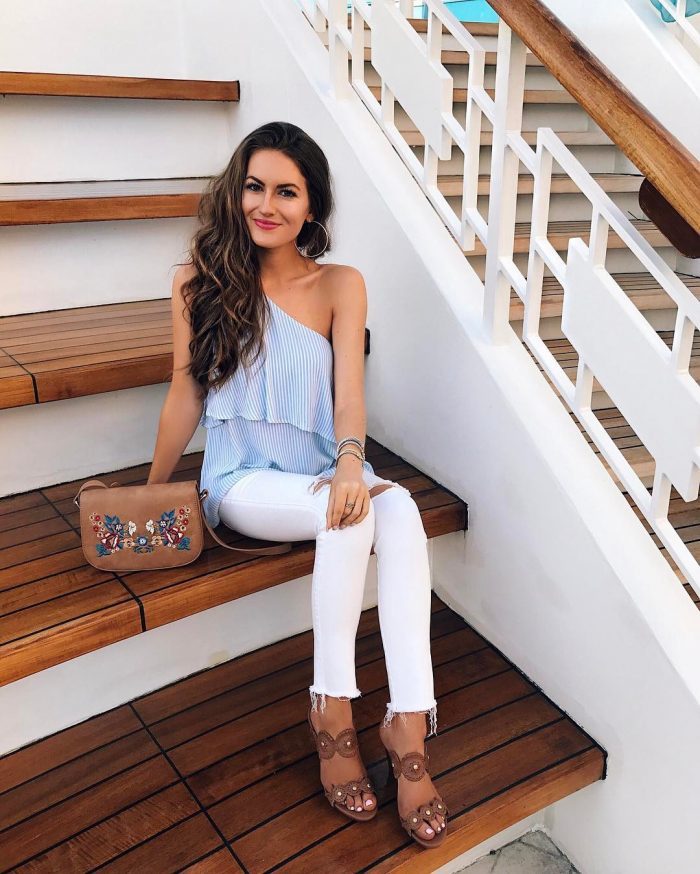 Caitlin knows that blue pinstripes go a treat with white jeans, as she pairs the two in an off the shoulder tank top, and distressed jeans. Finish this style with statement heels to complete the look. Shoes: Jack Roger.